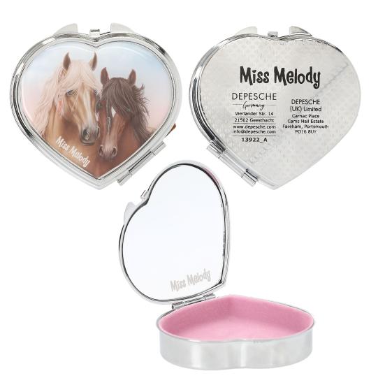 Heart-shaped compact mirror with horses on one side and brand information on the other, open to reveal a pink interior.