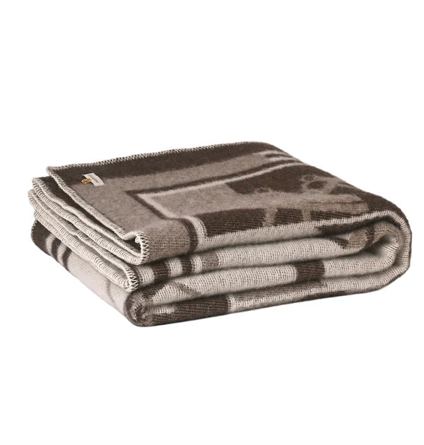 Folded brown throw on a white background