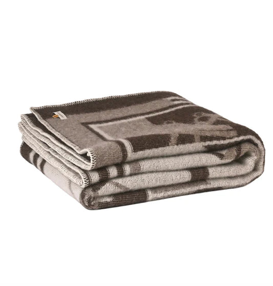 Folded brown throw on a white background