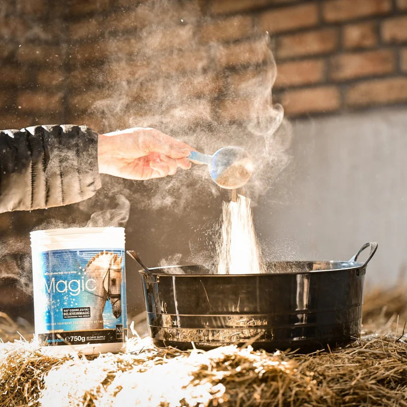 Person pouring a scoop over a container labeled 'Magic' on a rustic background