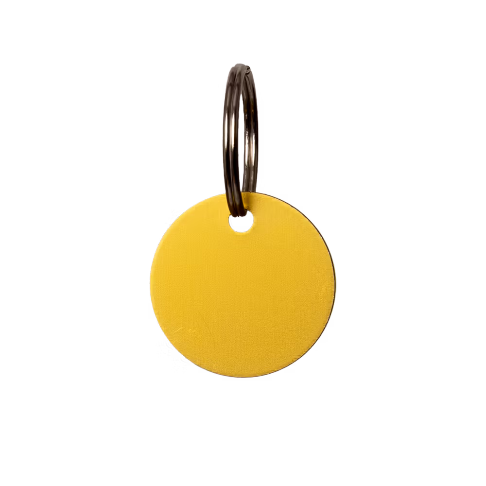 Yellow round keychain tag on a clear background