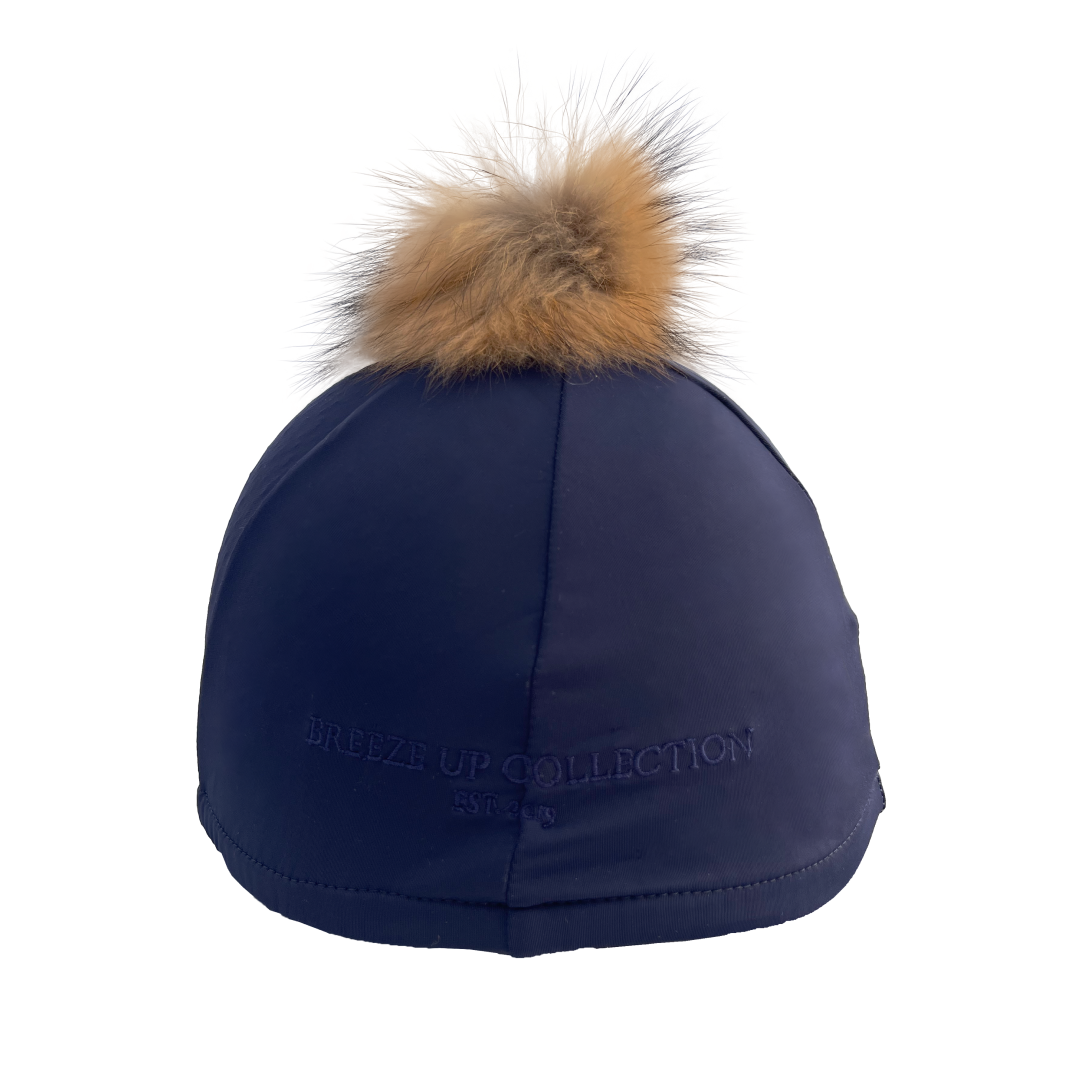 Navy blue hat silk with a fur pom-pom on a white background