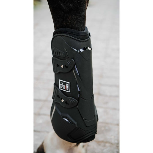 Black protective boot on a horse's leg with a visible brand logo.