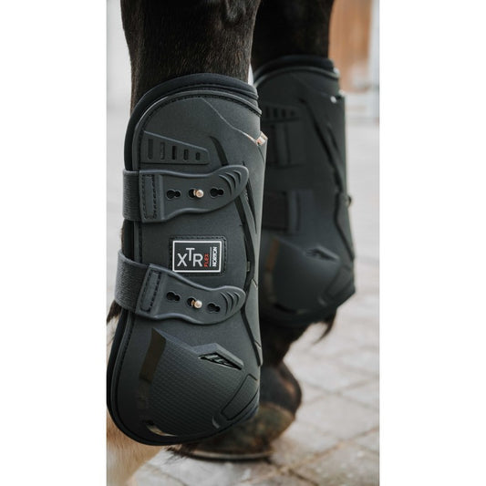 Black protective boot on a horse's leg with 'XTR' branding.