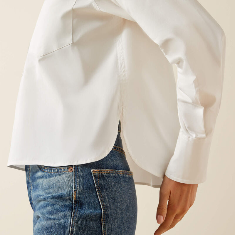 White blouse and blue jeans on a neutral background