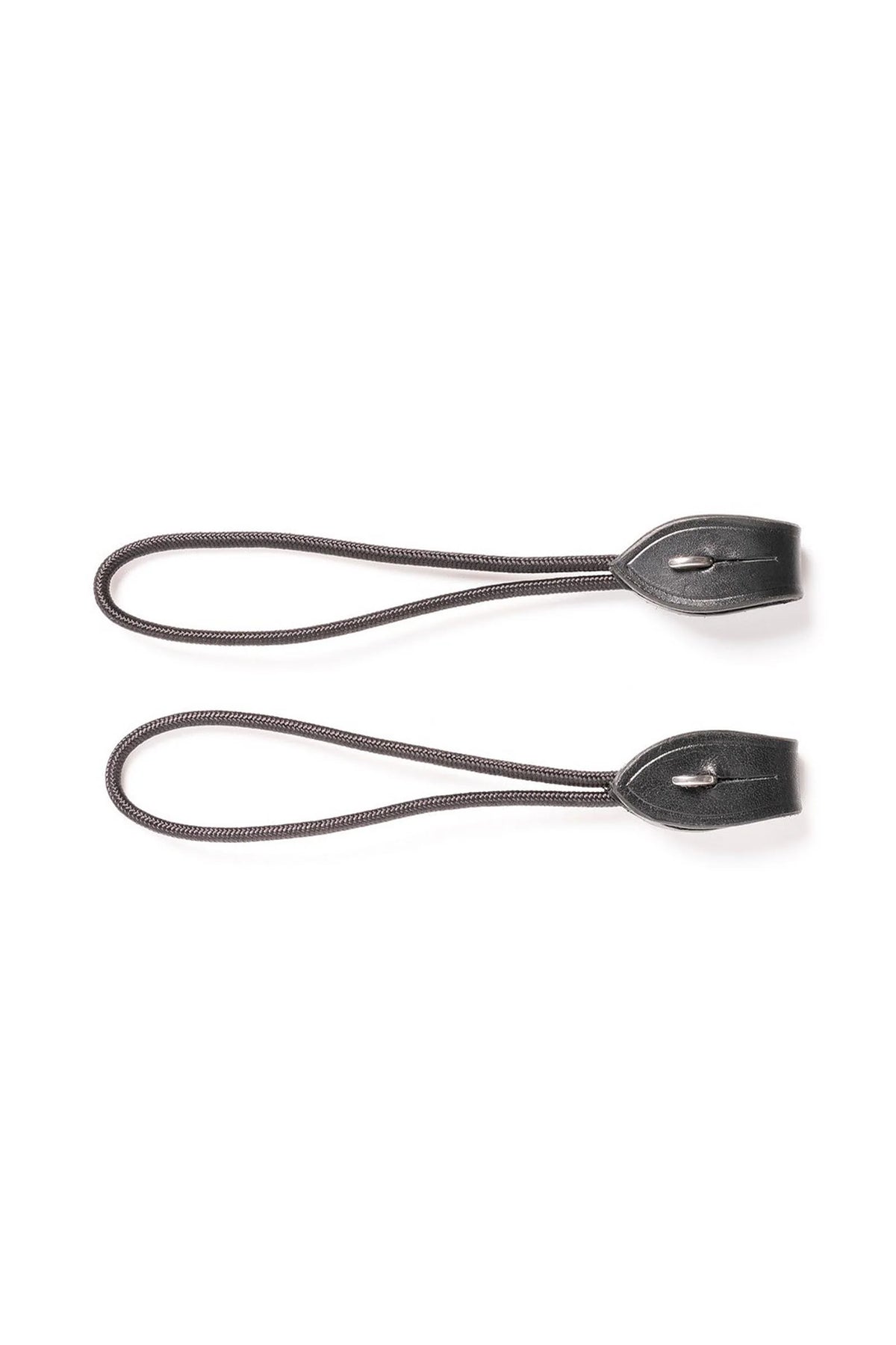 Two black leather strap accessories with oval loops and small metal rivets, laid flat on a white background.