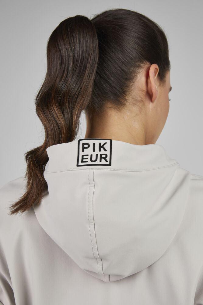 Person wearing a light gray hoodie with 'PIKEUR' logo on the back against a neutral background