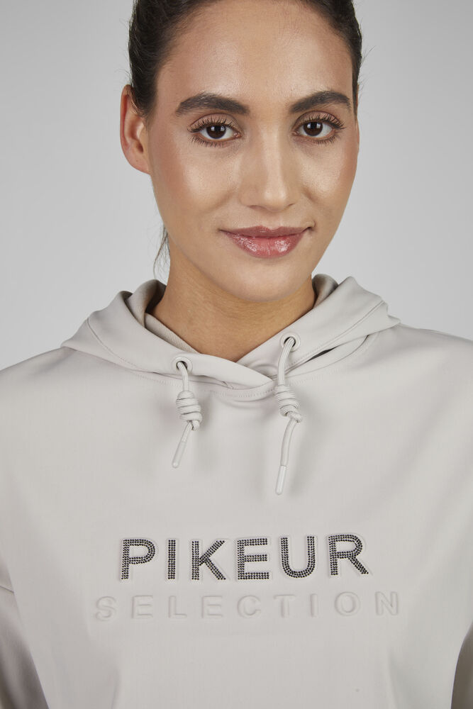 Person wearing a gray hoodie with 'Pikeur Selection' text on a plain background