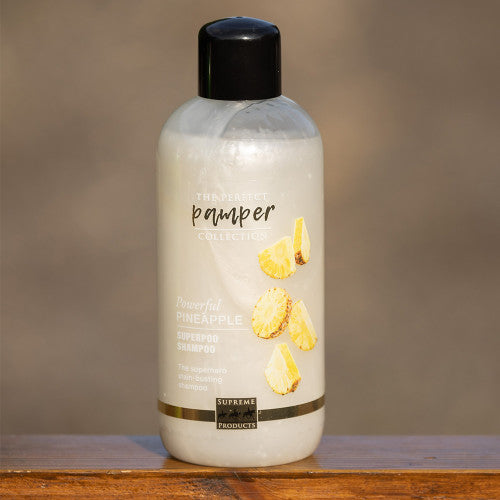 Pamper Supreme Products on a wooden ledge with a blurred background