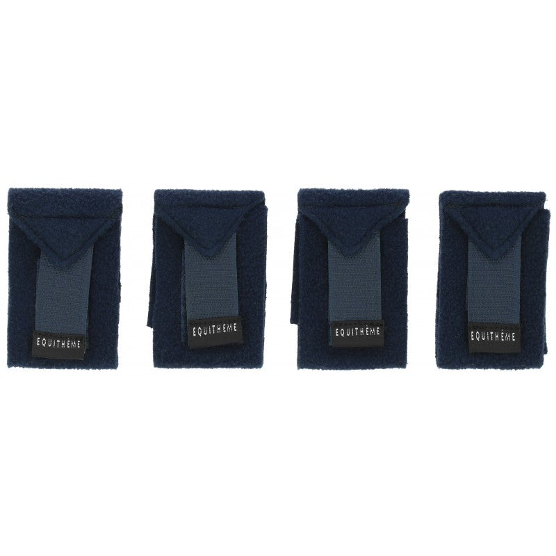 Four dark blue bandages with visible branding on a white background
