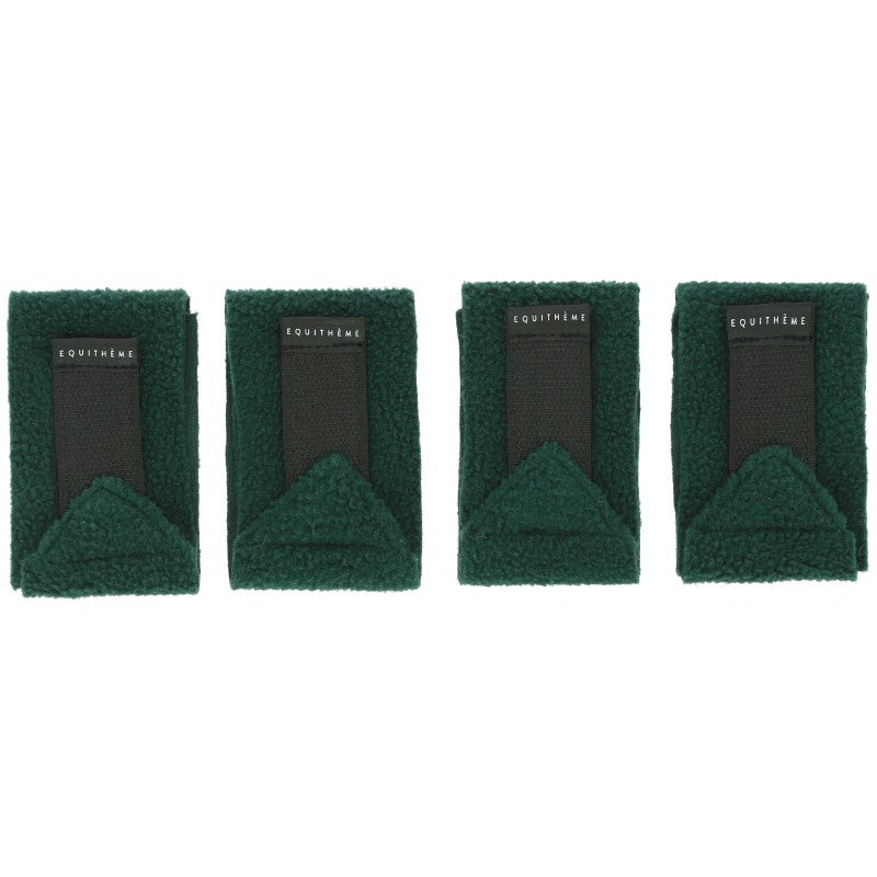 Four green bandages with black labels on a white background