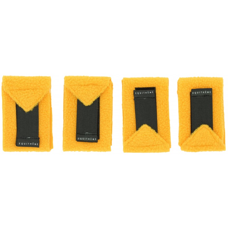 Four yellow bandages with black labels on a white background
