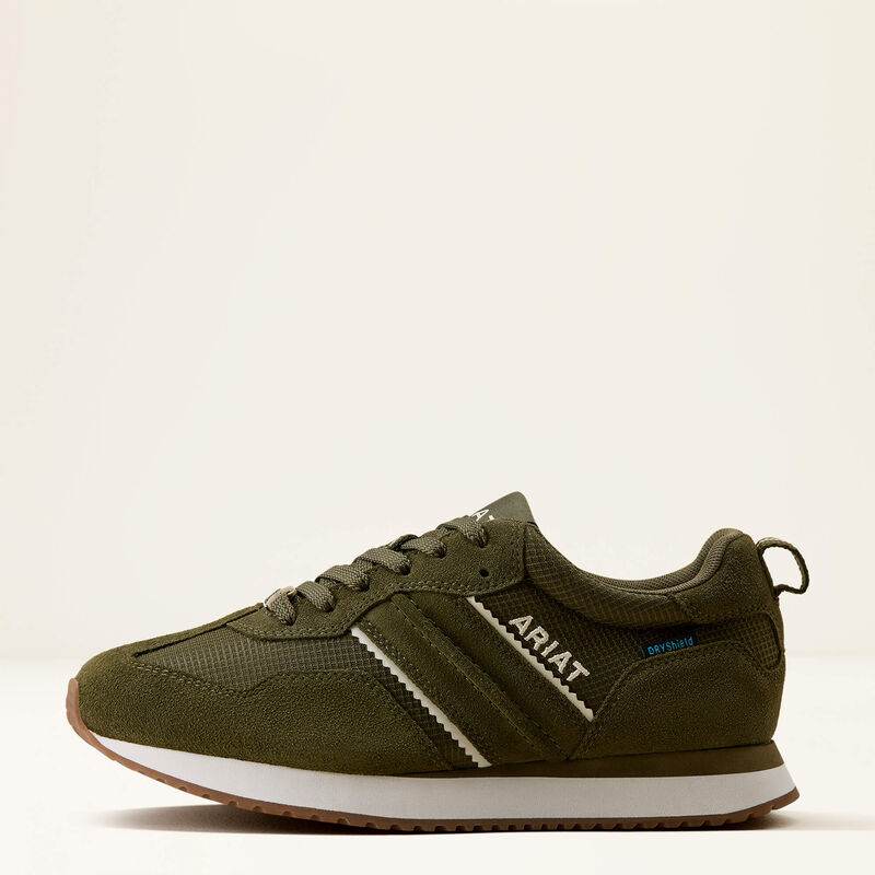 An olive green sneaker by ARIAT, featuring a textured mesh and suede upper, white side stripes with white branding, a white midsole, and a brown gum outsole, shown against a plain off-white background.