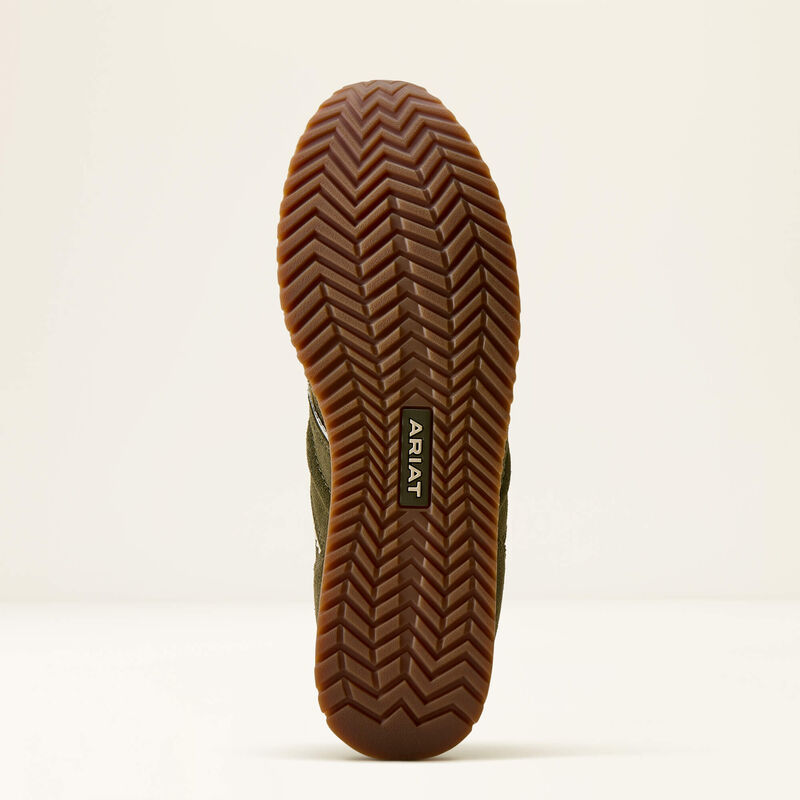 Close-up of a black sole with tread pattern on a beige background