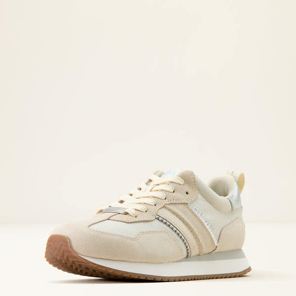 Beige sneaker with brown sole on a light beige background