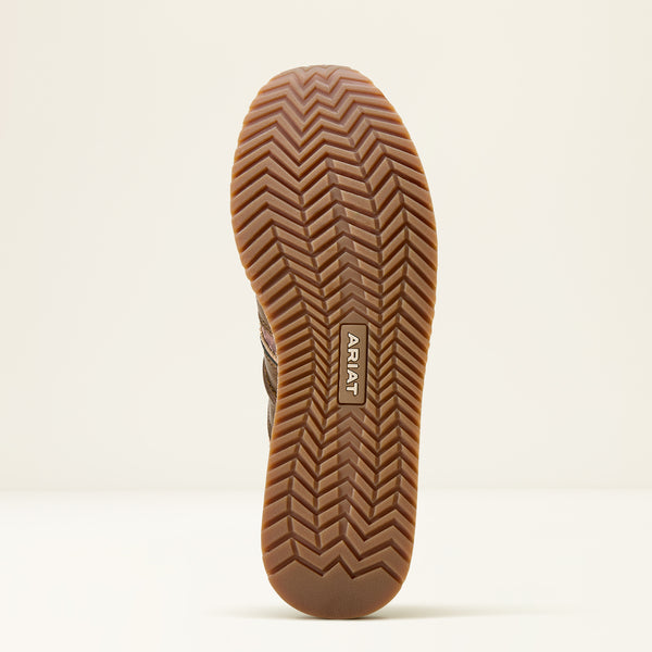 Close-up of a brown shoe sole with Ariat branding on a beige background