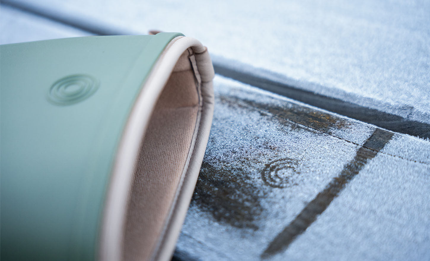 Close-up of a green and beige wellington