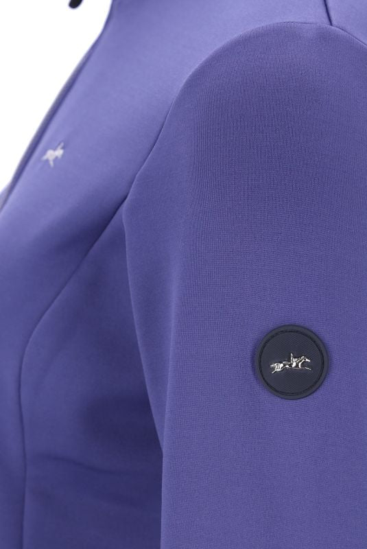 Close-up of a blue garment with a brand logo on a white background