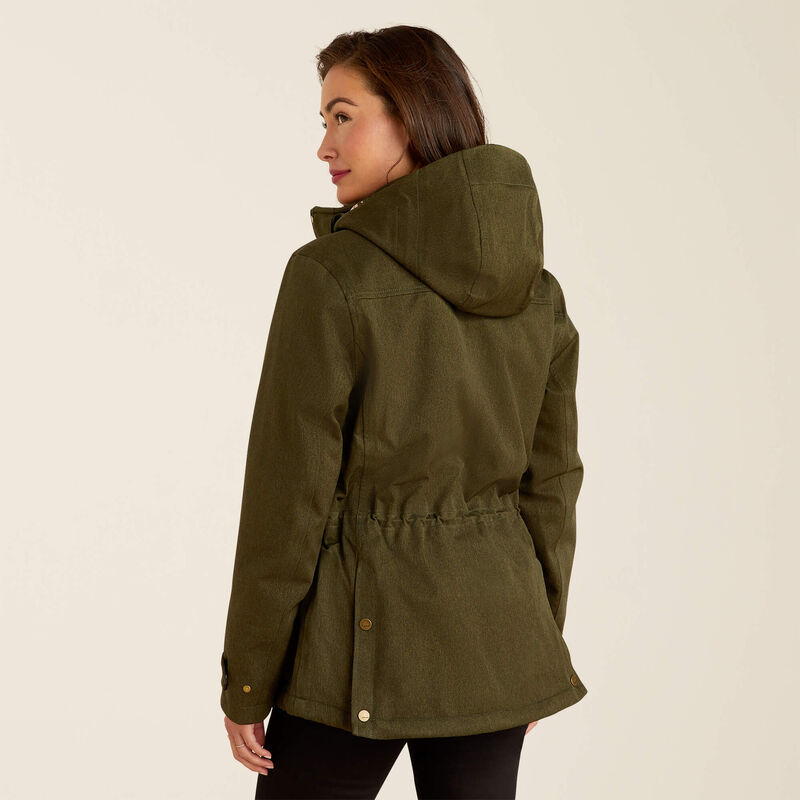 Woman wearing a green hooded jacket on a beige background