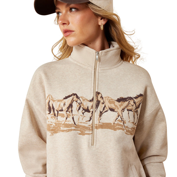 Woman wearing a beige sweatshirt with horse design on a white background