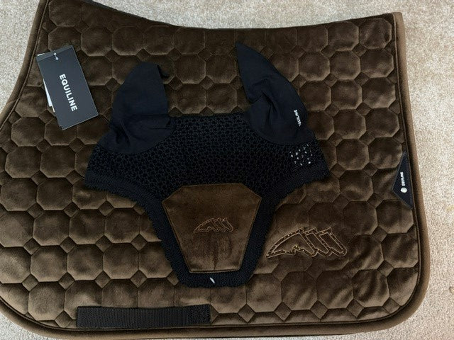 A dark brown quilted horse saddle pad with a black mesh fly veil and black leg bands, laid flat on a beige carpet. The brand name 'Fourline' is visible on the hangtag and a small tag near the bottom.