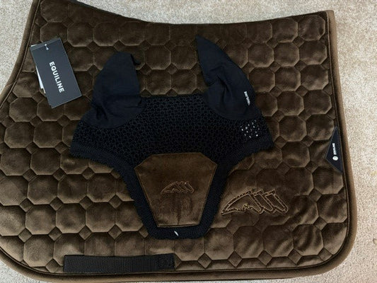 A dark brown quilted horse saddle pad with a black mesh fly veil and black leg bands, laid flat on a beige carpet. The brand name 'Fourline' is visible on the hangtag and a small tag near the bottom.