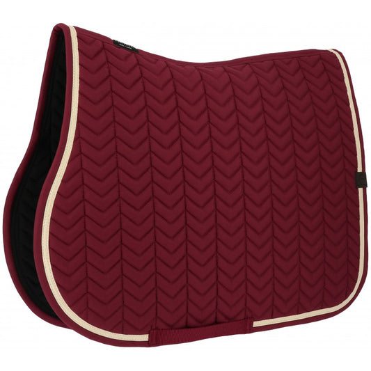 Red quilted saddle pad with white trim on a white background