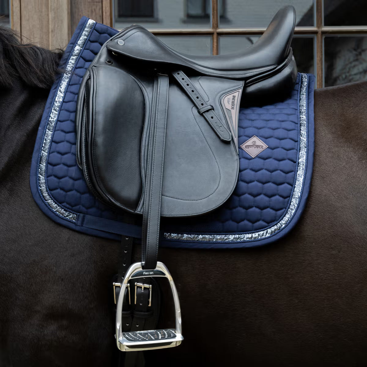 Navy glitter saddle pad on a horse with a black saddle