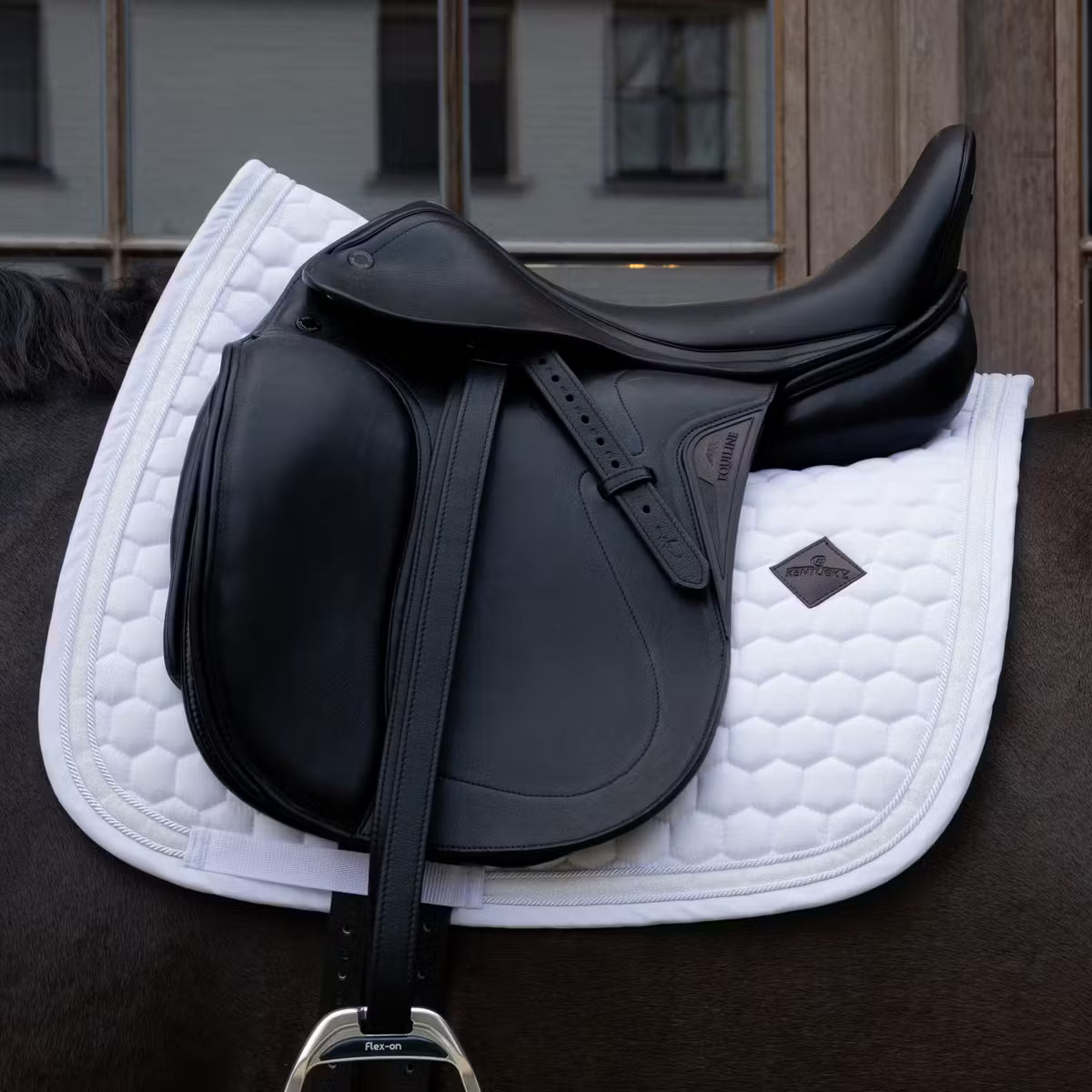 Glitter white dressage saddle pad on a horse with a black saddle