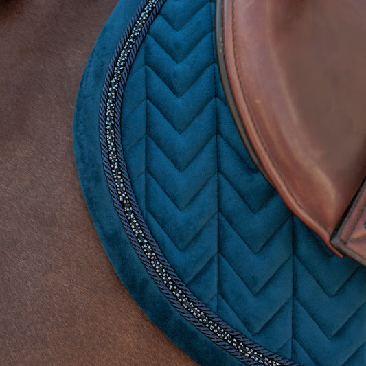 Close up of a navy saddle pad with mini pearls 