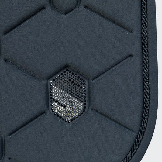 Close-up of a textured saddle pad with a brand logo.