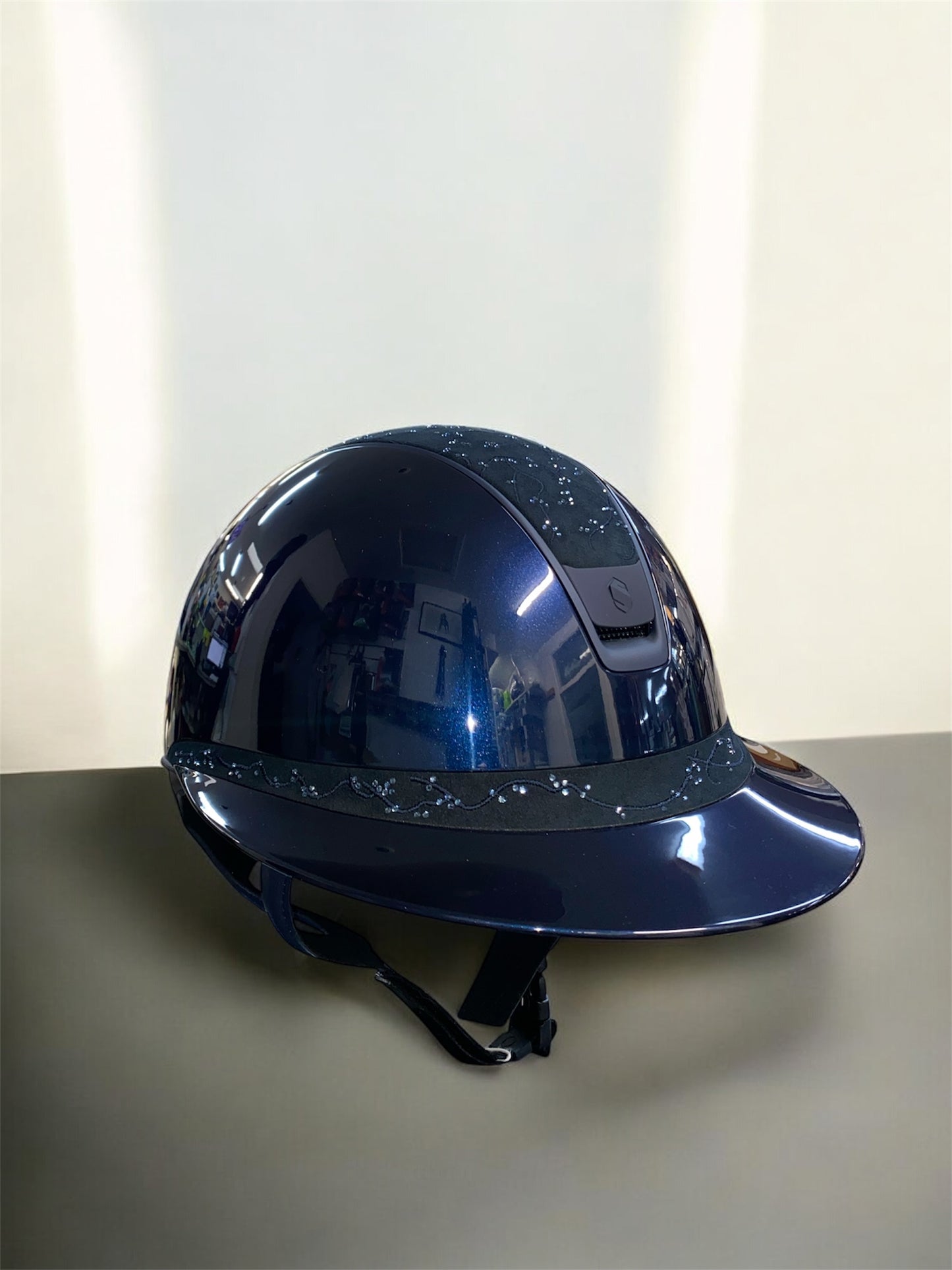 Blue hard hat on a reflective surface with a light background