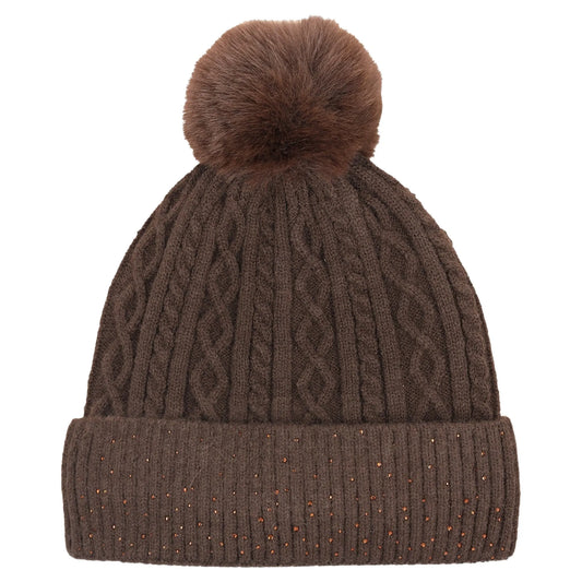 A brown cable-knit beanie hat with a matching faux-fur pom-pom on top and a ribbed cuff decorated with small metallic glitter specks, shown against a plain white background.