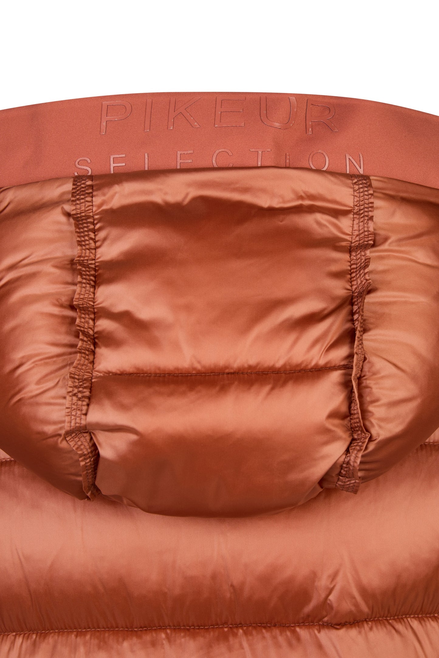Close-up of a red puffer jacket with 'PIKEUR SELECTION' branding.