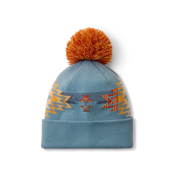 Blue beanie with colourful pom pom on a white background 