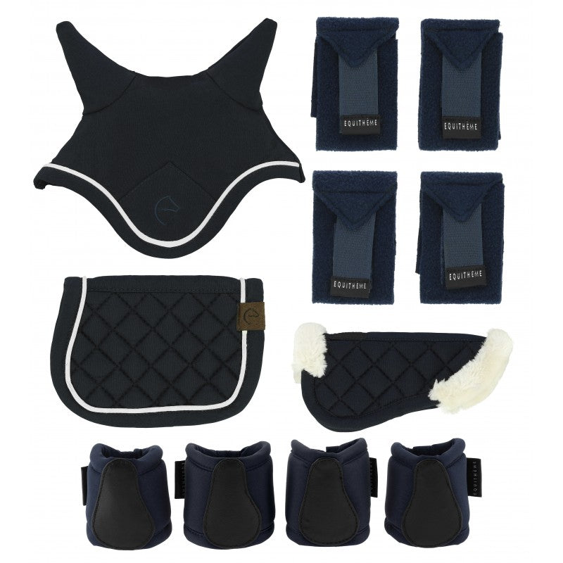 Set of equestrian protective gear including a back guard, saddle pad, leg wraps, and front leg guards on a white background.