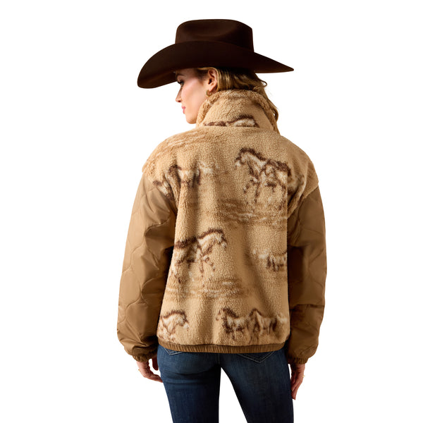 A woman shown from the back wearing a brown cowboy hat, a tan sherpa fleece jacket with a brown horse pattern, and blue jeans against a plain white background.