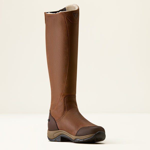 A single brown leather knee-high riding boot with a dark brown heel panel, tan midsole, and black outsole, shown against a plain off-white background.