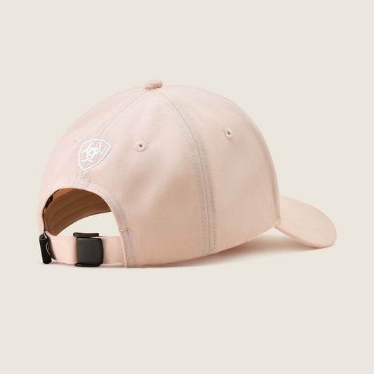 Pink baseball cap with a logo on a beige background
