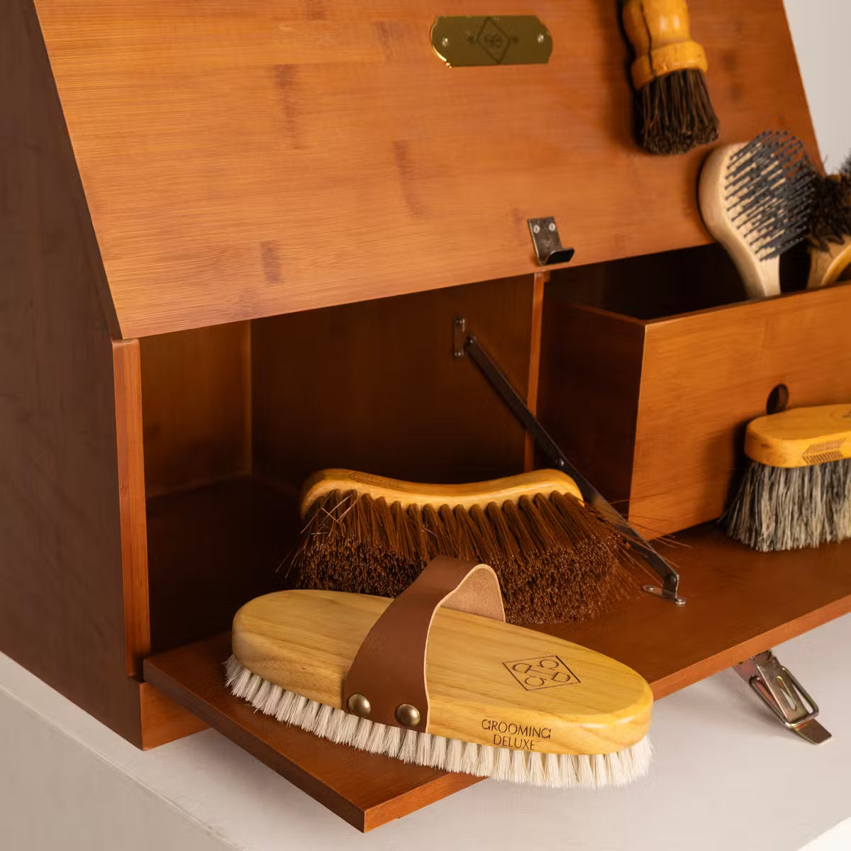 Wooden grooming cabinet with brushes and a mirror