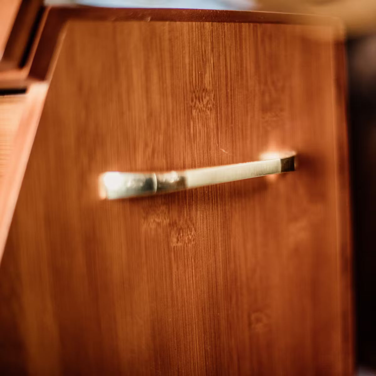 Close-up of a wooden drawer with a metal handle