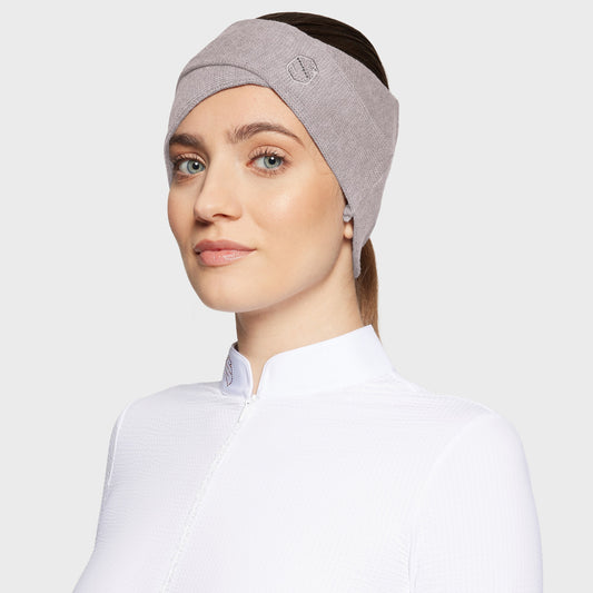 Woman wearing a gray headband on a light gray background