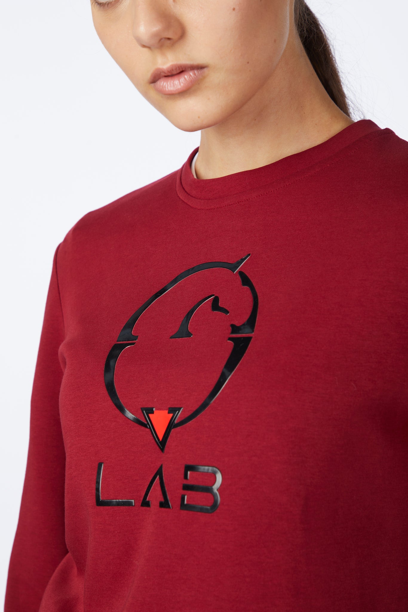 Red sweatshirt with a black and red logo on a white background