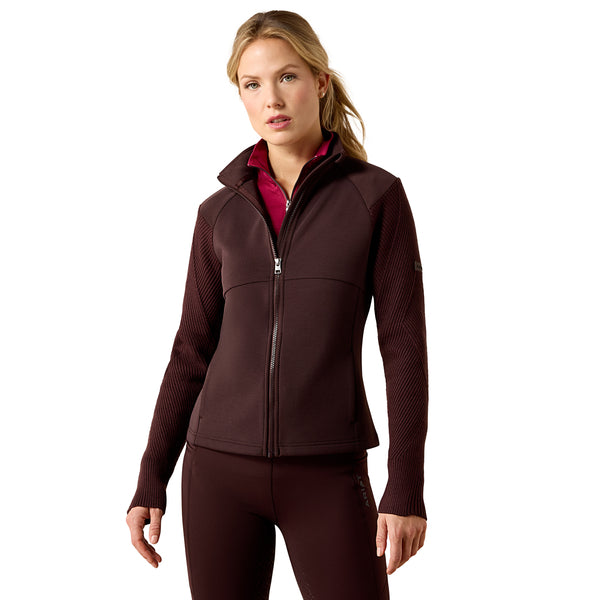 A woman modeling a dark brown full-zip fleece jacket with textured knit sleeves and matching dark brown leggings against a solid white background.