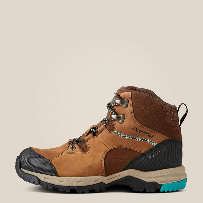 Brown hiking boot with black sole on a beige background