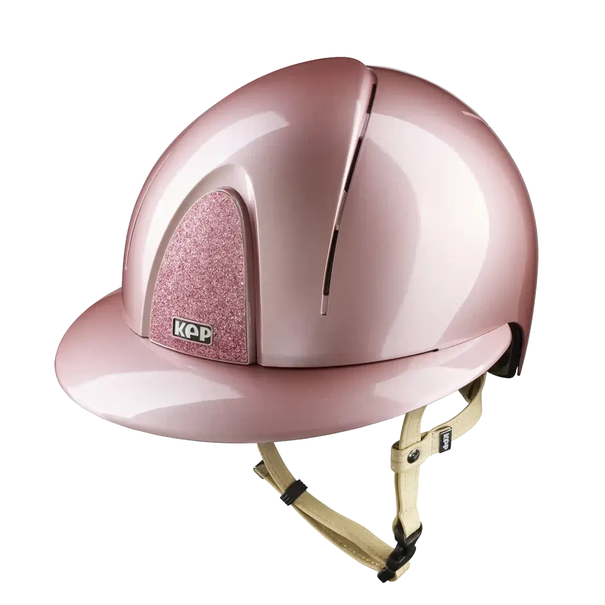 A metallic pink equestrian riding helmet with a glittery pink cheek protector and a beige chin strap, shown on a solid white background.