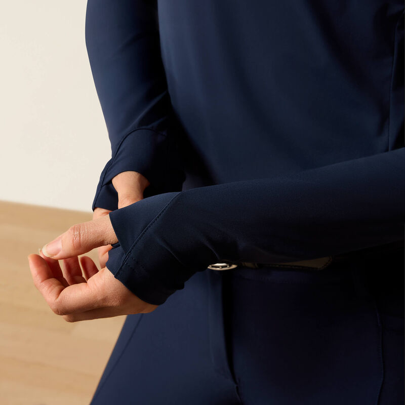 Person wearing a navy blue outfit with a close-up of the sleeve and hand.