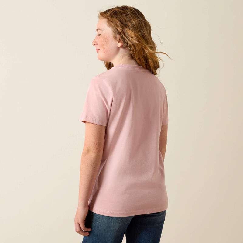 Person wearing a pink t-shirt against a beige background