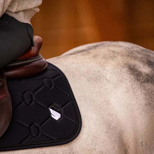 Detail of a black Samshield saddle pad on a grey horse