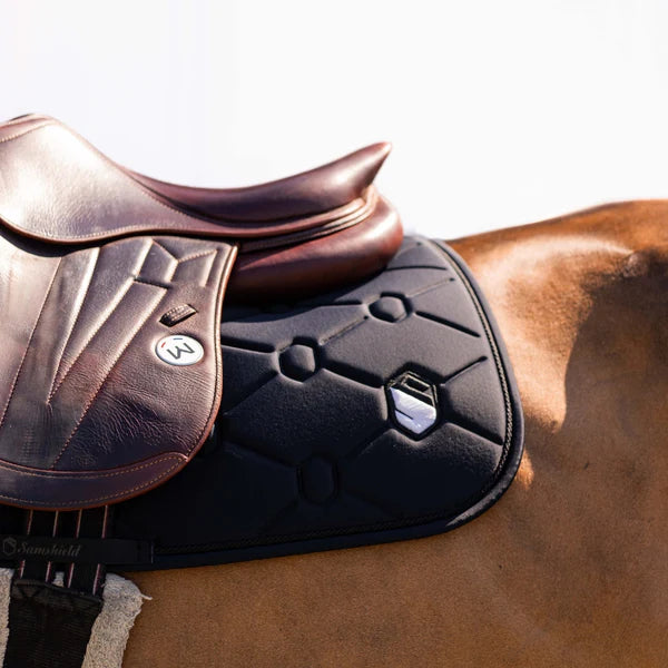 Detail of a black Samshield saddle pad on a brown horse